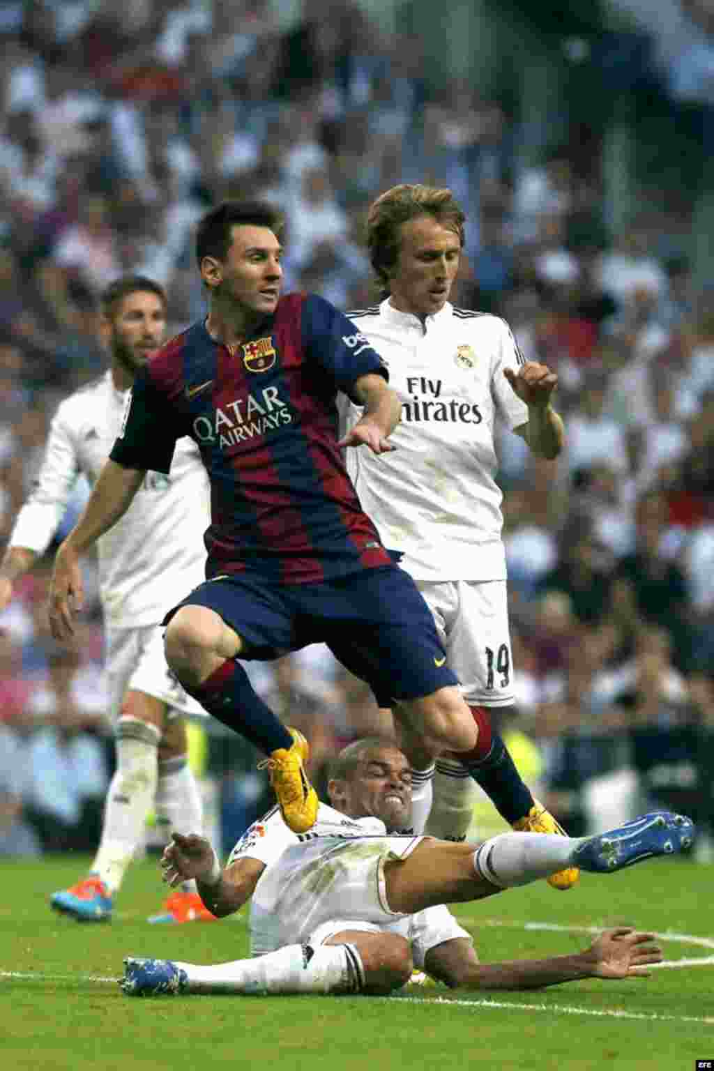 El delantero argentino del FC Barcelona Lionel Messi (i) y el defensa portugués del Real Madrid Kléper Laveran "Pepe" (abajo), durante el partido de la novena jornada de Liga de Primera División disputado el sábado 25 de octubre en el estadio Santiago Bernabéu.